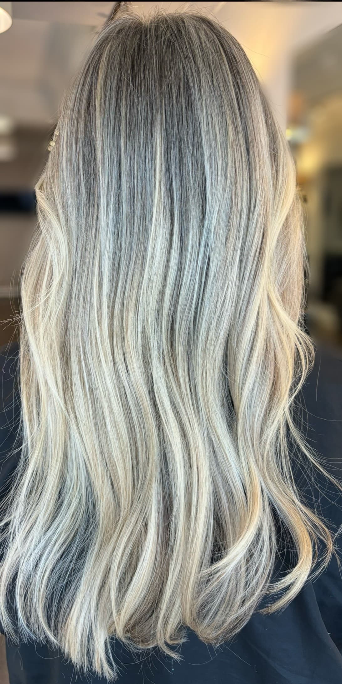 Cool-toned blonde balayage result on long hair.